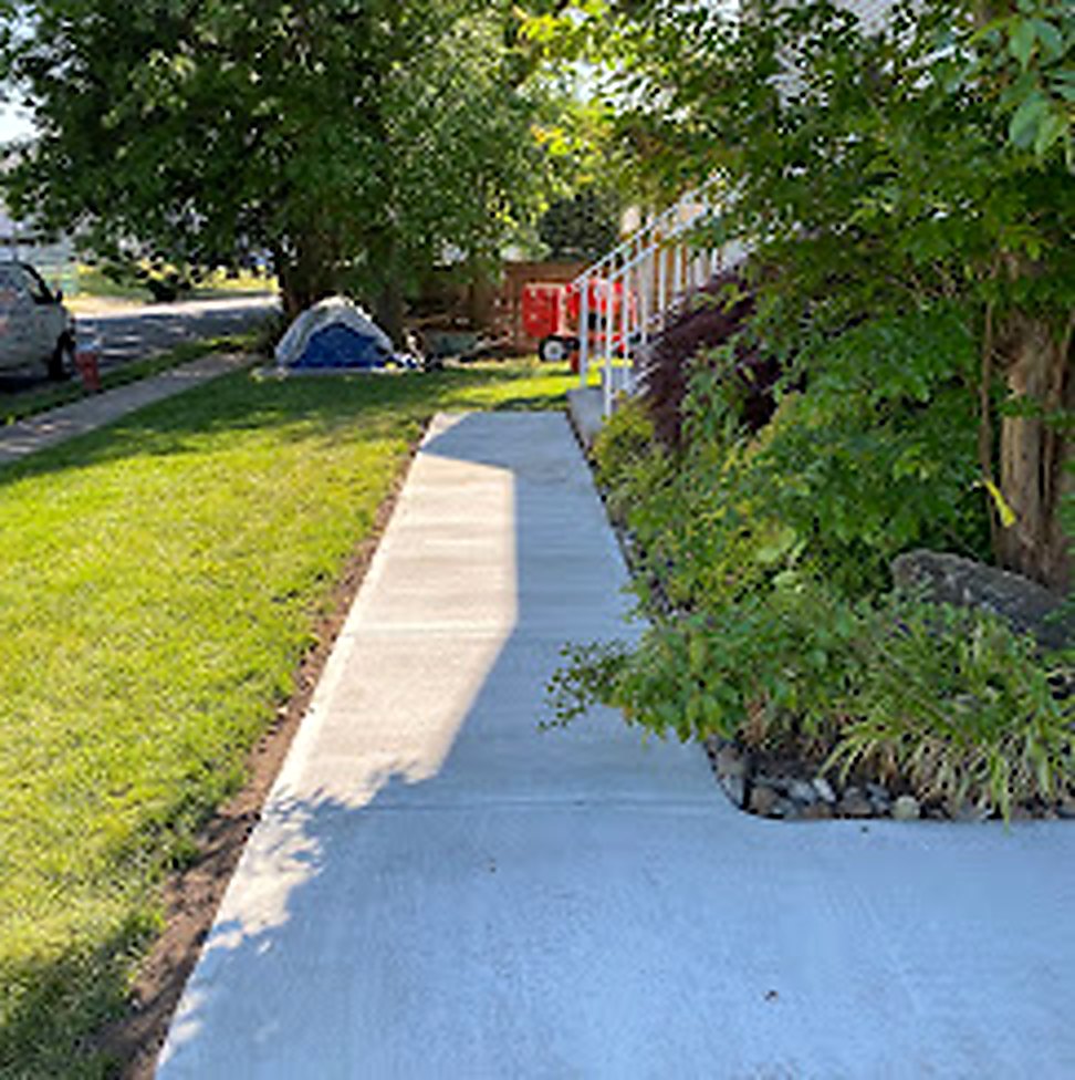Finished concrete walkway alongside a residential home